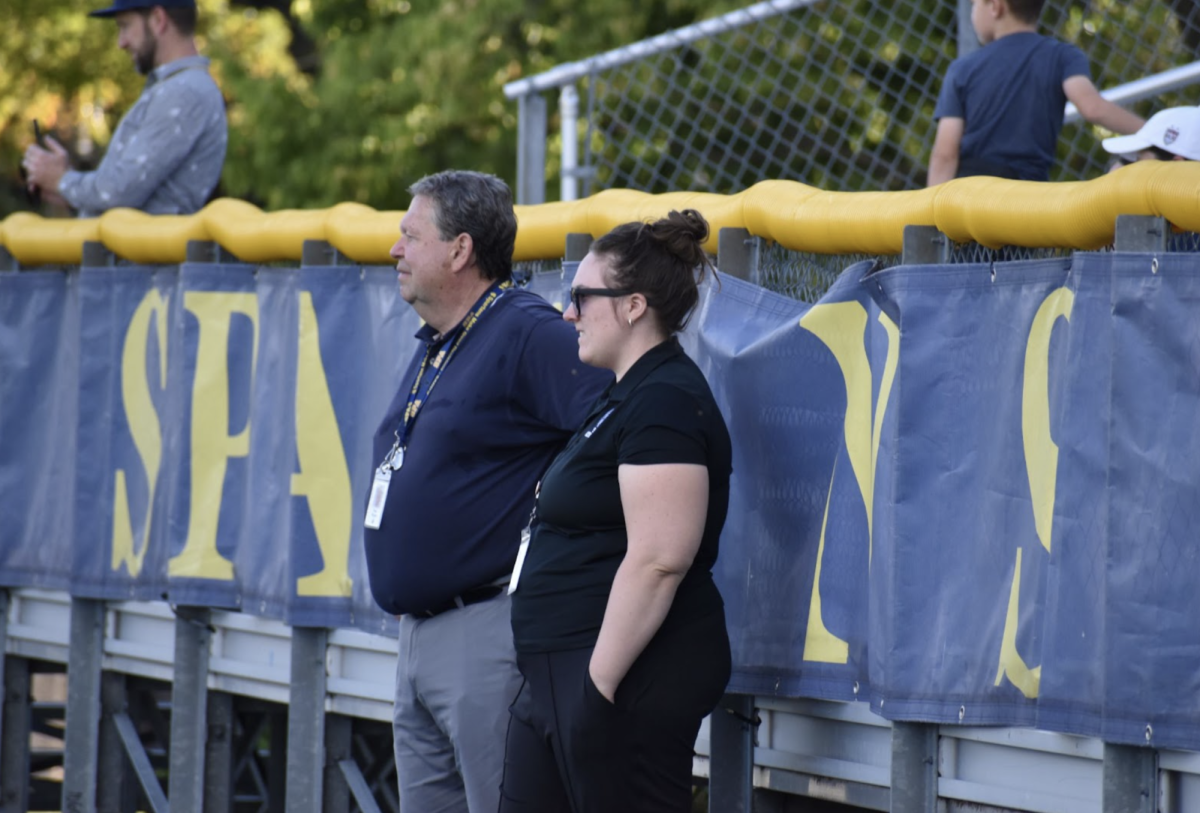 SUPPORT SPARTANS. Director of Athletics Paul Moyer and Administrative Assistant Hope Walcheski watch the game closely.
